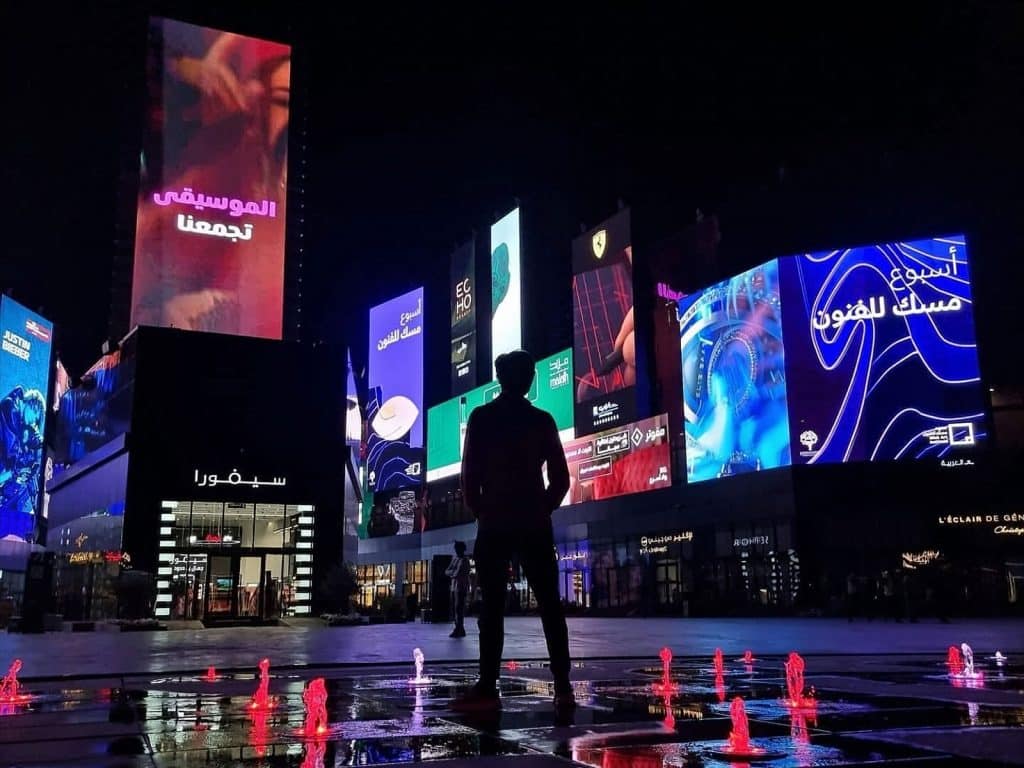 person looking at city billboards