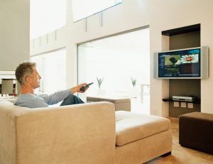 gentleman in eastern europe watching tv at home