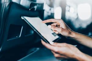 person using tablet on plane