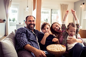 video service photo of family watching tv for cee event